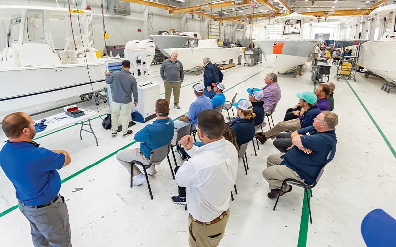 Factory training session at Regulator Marine with Bluewater Yacht Sales team members learning about boat construction