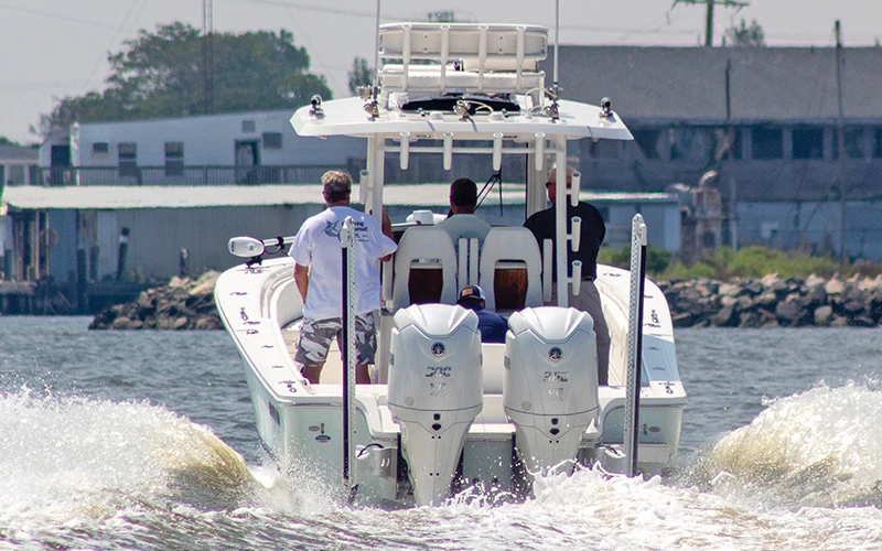 Rear view of a Regulator center console boat with dual Yamaha XTO outboards powering through the water