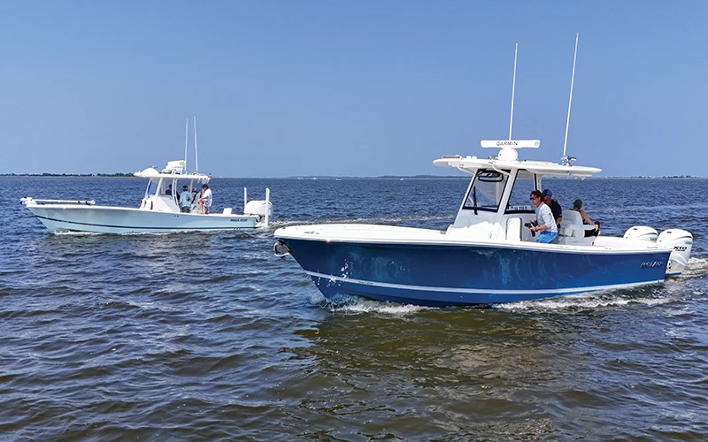 Two Regulator center consoles cruising side-by-side on open water during a summer demo event