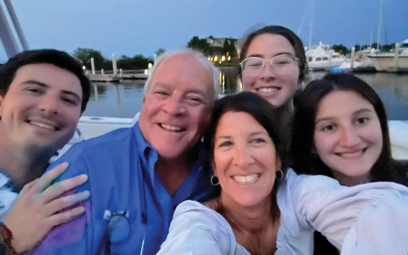 Jim and Judy Belliveau smiling with their children during a sunset outing aboard their Regulator 34