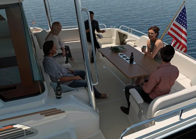 Cockpit entertaining area of the Sabre 51 with guests enjoying seating around a large table and American flag flying aft