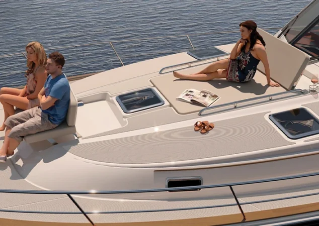 Bow lounge area of the Sabre 51 with guests relaxing on sun pads and seating under open skies