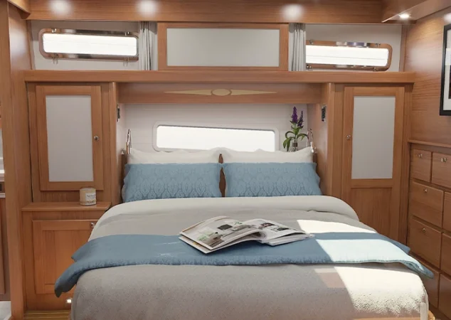 Master stateroom aboard the Sabre 51 showcasing premium wood finishes, soft lighting, and elegant design