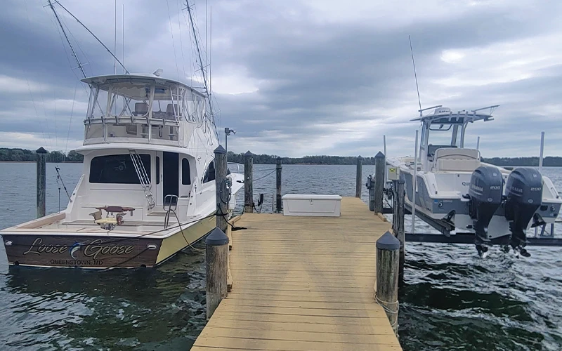 The Loose Goose Ocean Yacht docked alongside a Sea Hunt center console at a private pier