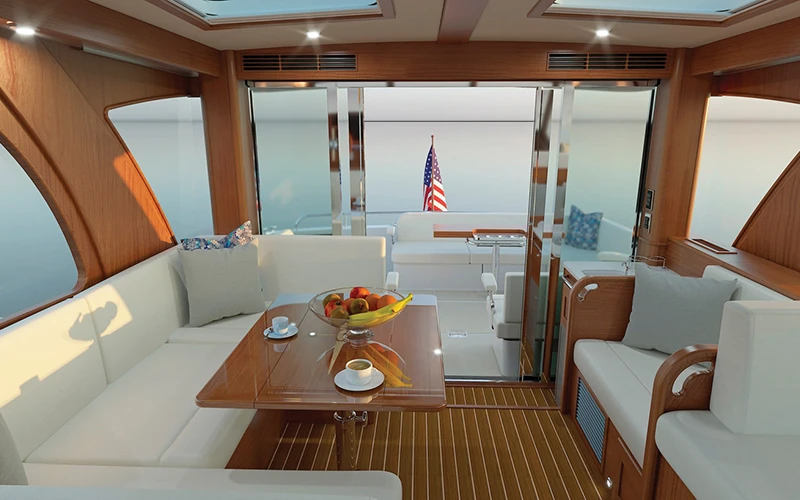 Salon seating and dinette aboard the Sabre 51 with aft doors open to the cockpit for seamless indoor-outdoor flow