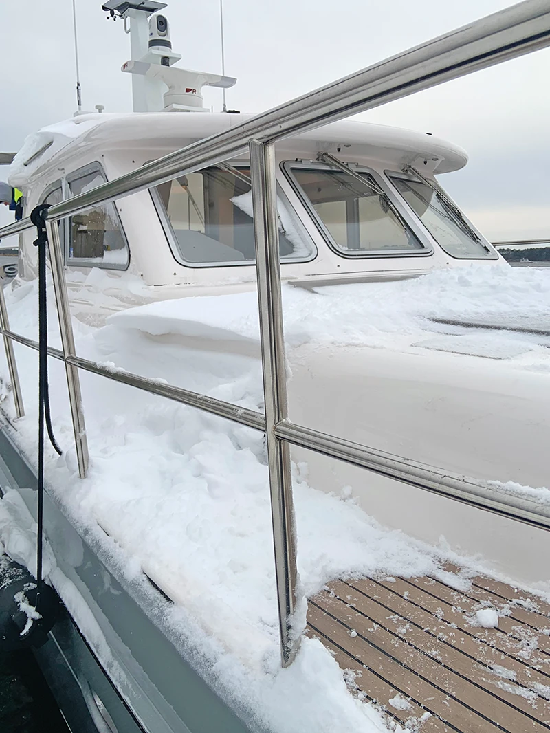 Snow-covered deck and bow of the Elling E4 docked during winter conditions in the Chesapeake Bay