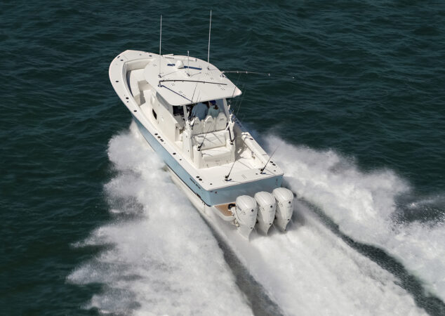 Regulator 37 charging through the ocean, bow lifted as water sprays outward