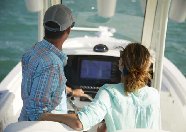 Couple seated at the helm of the Regulator 26XO