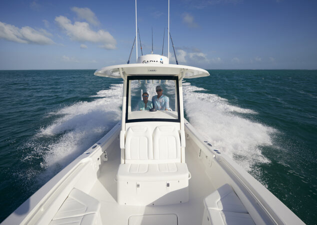 Couple cruising behind integrated wraparound windshield on Regulator 26XO