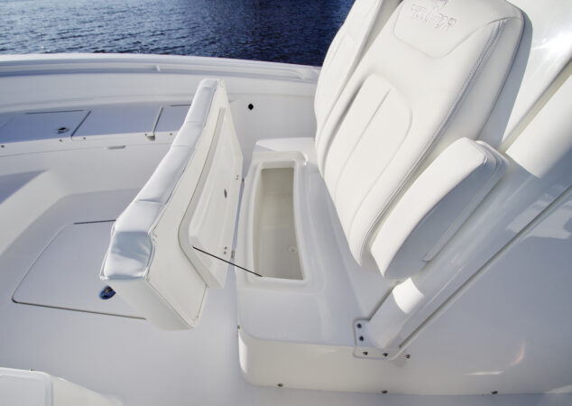 Forward-facing console seat lifted to reveal insulated storage compartment