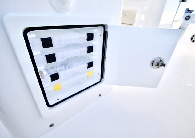 Open tackle storage hatch with Plano-style boxes on Regulator 26XO