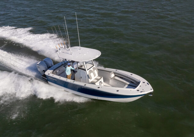 Overhead view of a Regulator 25 center console cruising offshore with twin Yamaha outboards and cushioned seating visible