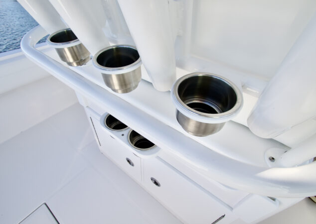 Cup holders and rod holders integrated into the back of the leaning post