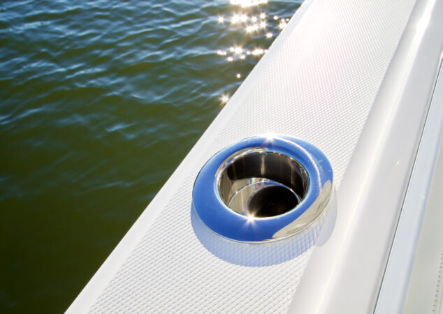 Flush-mounted stainless steel rod holder on the gunwale