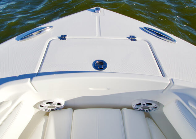 Forward bow storage hatch with stainless hardware and speakers beneath seating