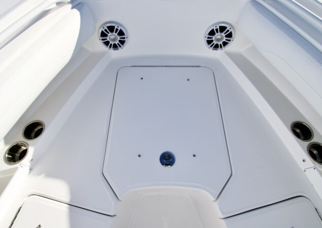 Bow hatch closed, flush with the deck, surrounded by speakers and cup holders