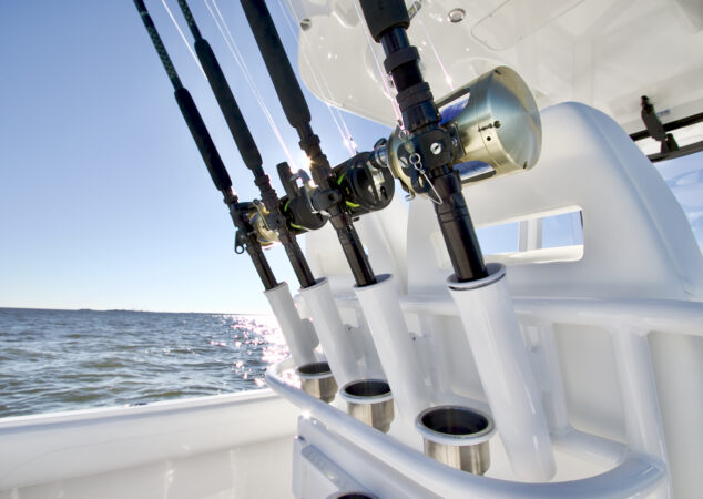 Multiple fishing rods stored in leaning post rod holders facing aft