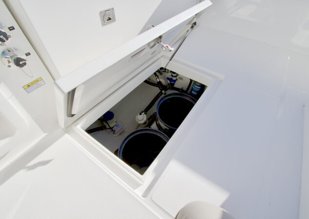 In-deck bilge access hatch open, showing pumps and system components