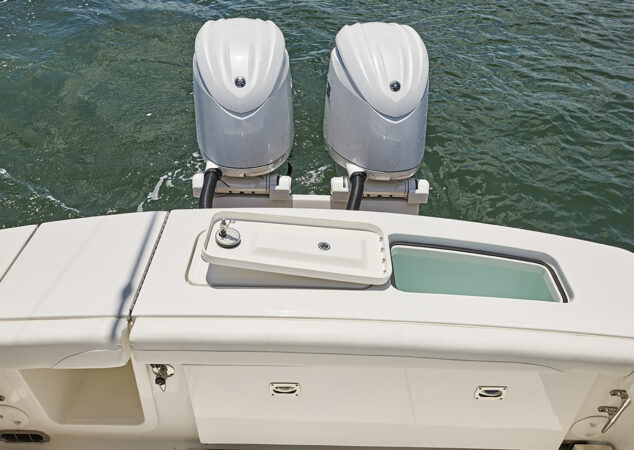Twin Yamaha outboards with livewell and storage compartments along the transom
