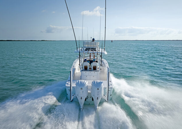 Stern view of the Regulator 30XO running, showcasing twin Yamaha outboards and cockpit layout