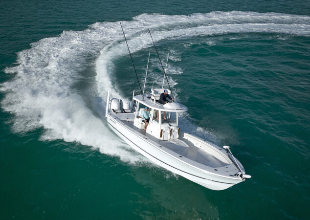 Aerial view of the Regulator 30XO carving a sharp turn, leaving a wide wake in turquoise water