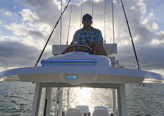 Angler at the upper station helm silhouetted against the sun on the Regulator 30XO