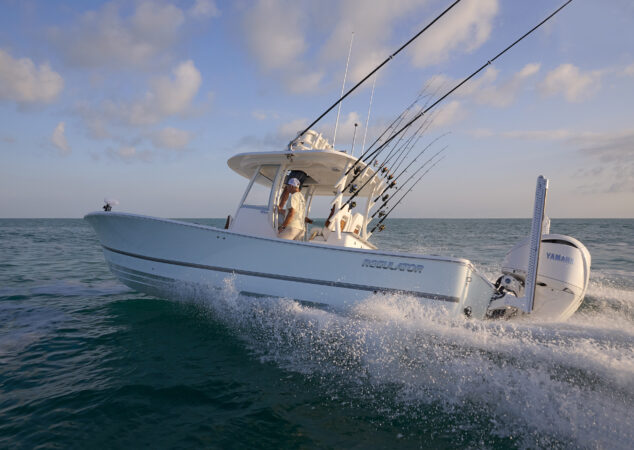Port-side running shot of the Regulator 30XO with multiple fishing rods set in transom holders