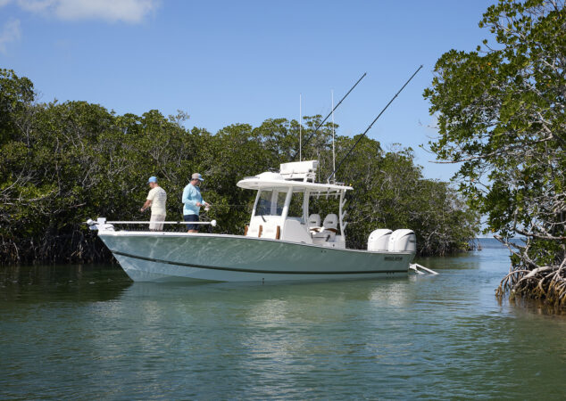 Anglers fishing from the bow of a Regulator 30XO tucked into mangrove-lined shallows