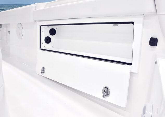 Side compartment open, revealing interior storage space and mounted speakers