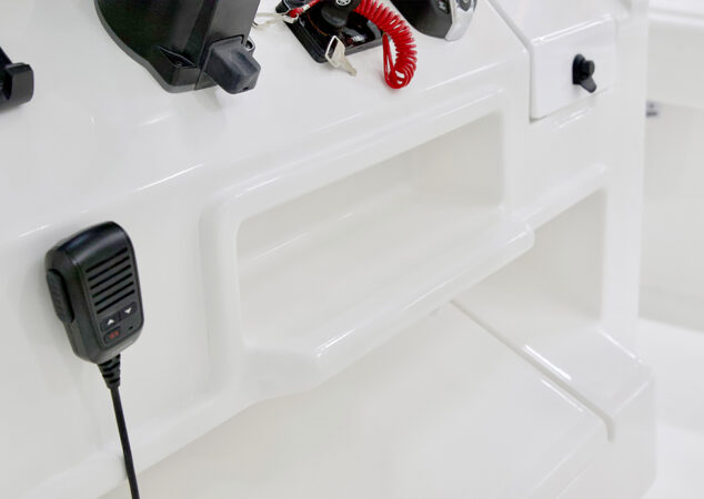 Lower helm console storage shelf with mounted VHF radio mic