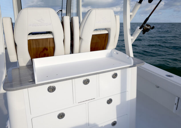 Cockpit tackle center with Corian counter and drawers, positioned behind embroidered Regulator helm chairs