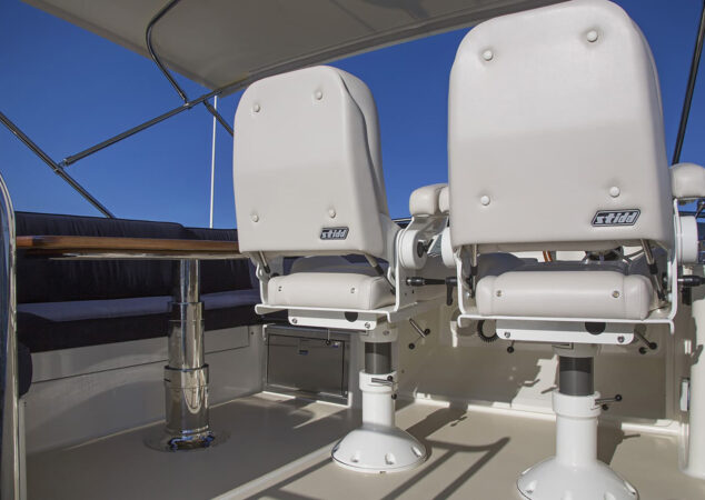 Flybridge helm seating and companion bench with table on the Sabre 48 Fly Bridge