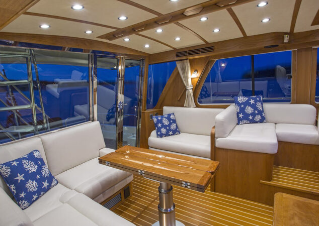 Salon seating area with foldable high-gloss wood table and large windows providing natural light