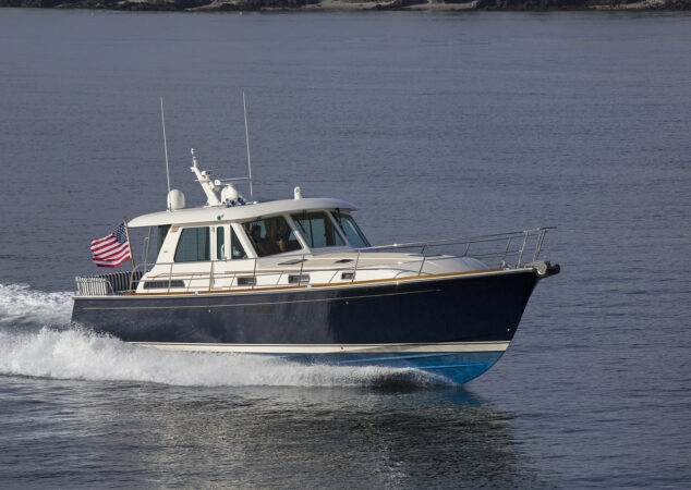 Portside view of Sabre 48 Salon Express gliding across open water with bow spray visible
