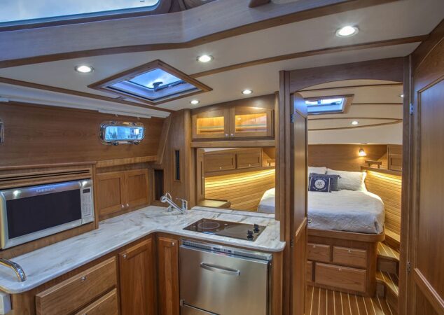 Sabre 38 Salon Express lower galley with cooktop, sink, and view to master