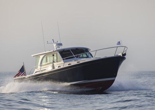 Back Cove 412 running at speed port bow view with spray coming off the hull