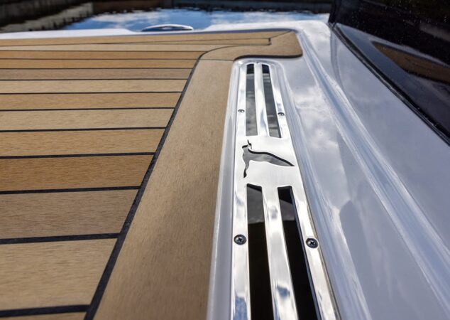 Back Cove 372 teak swim platform with polished stainless steel bird logo detail