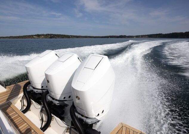 Wake shot of the Back Cove 39O showing triple outboard engines in action