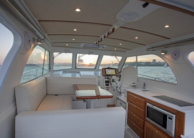 Interior helm and dinette of Back Cove 34O with panoramic windows