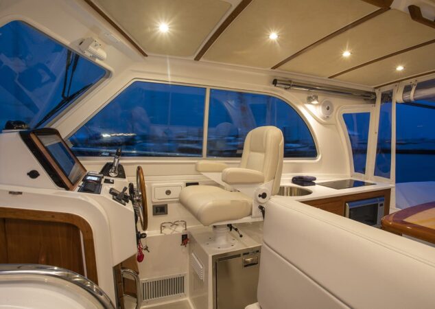 Captain’s helm chair and galley area aboard Back Cove 34O