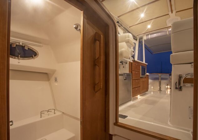 Companionway view looking aft from the cabin, highlighting the doorway to the head and the galley area above on the Back Cove 34O