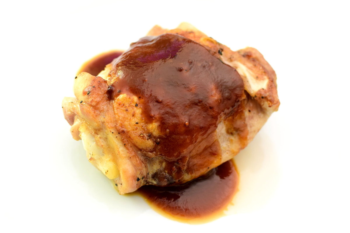 Our BBQ sauce coating a roasted chicken thigh.