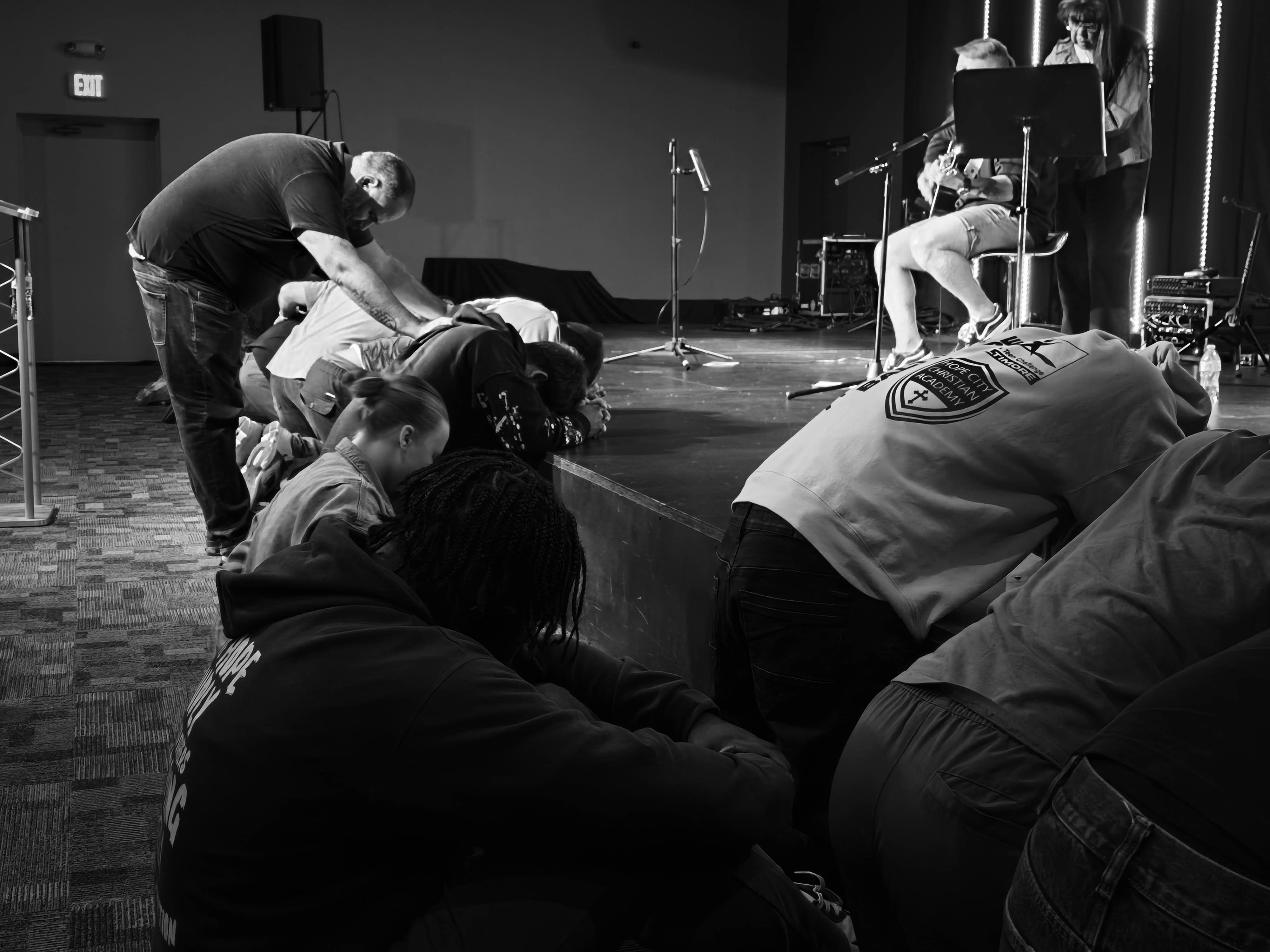 People gathered in prayer at Hope City Church