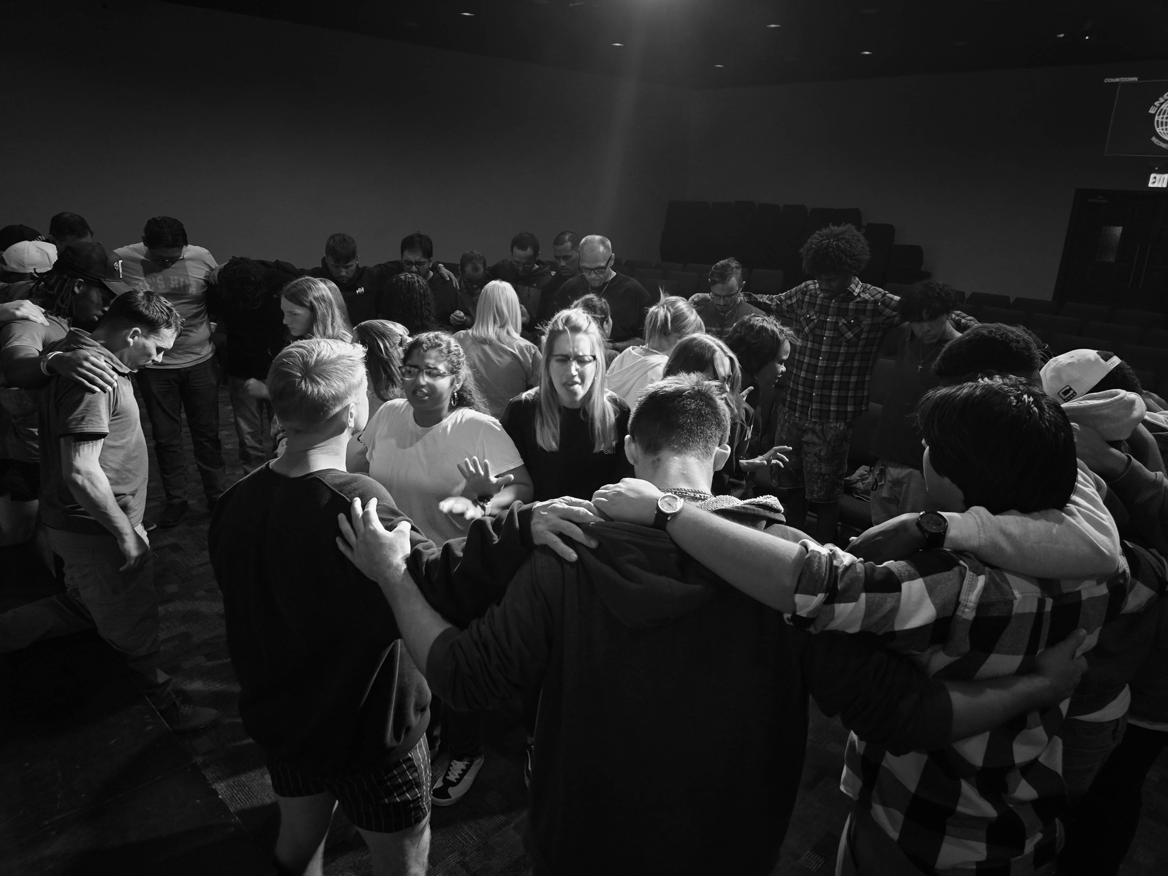 People gathered together in prayer at Hope City Church