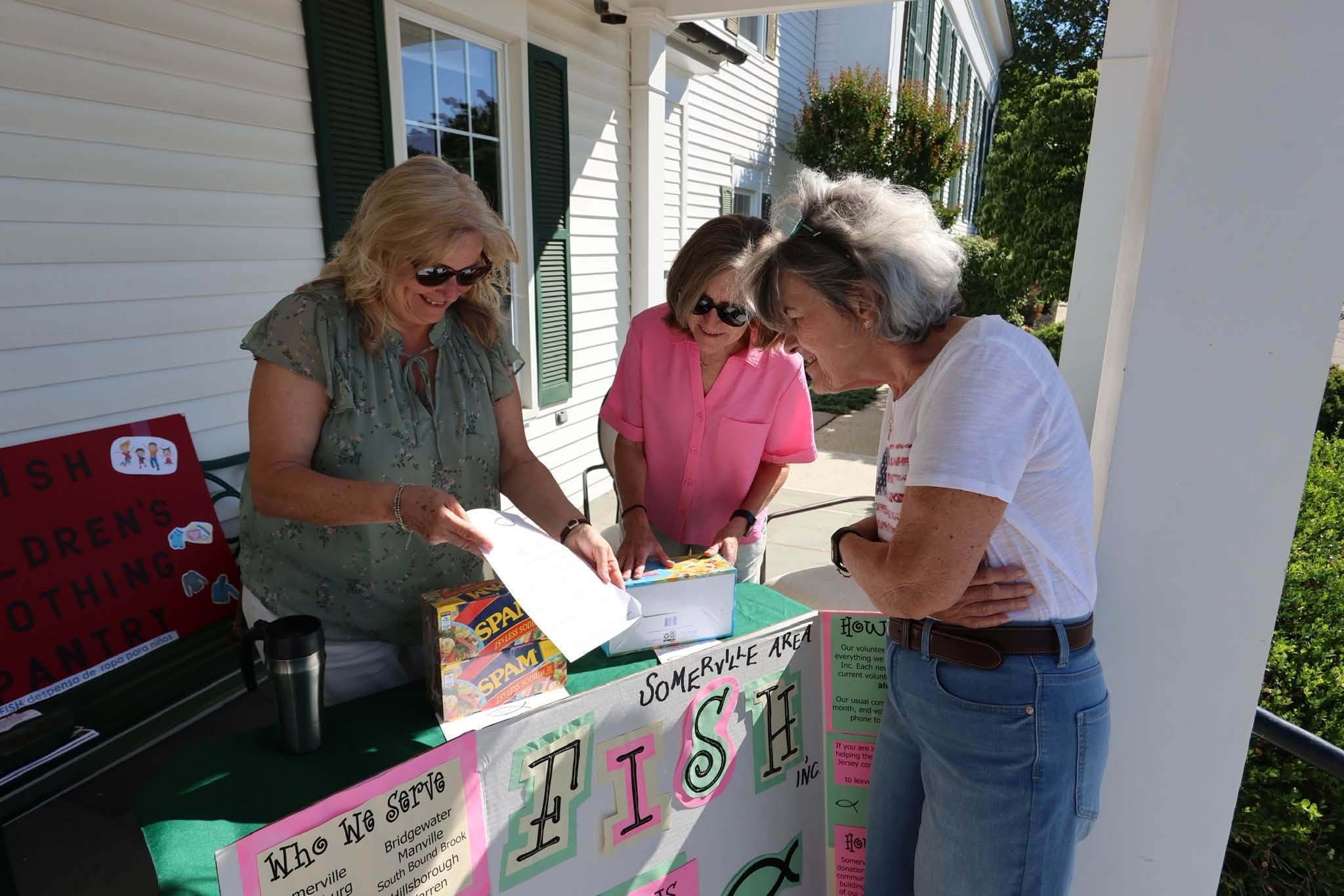 Volunteers at the Somerville Area FISH donation table on the church porch