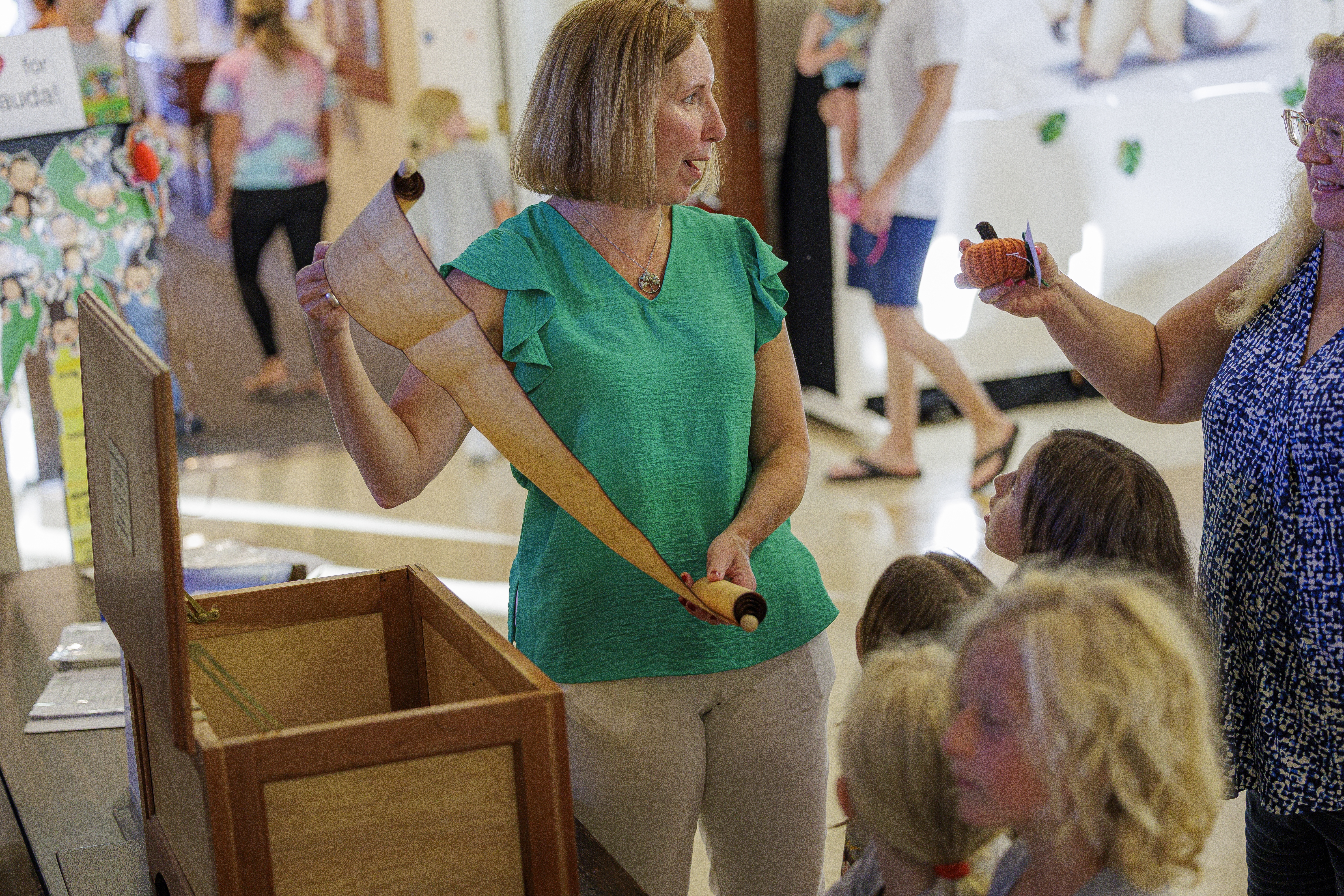 A scroll being shown to children before it is placed in the time capsule