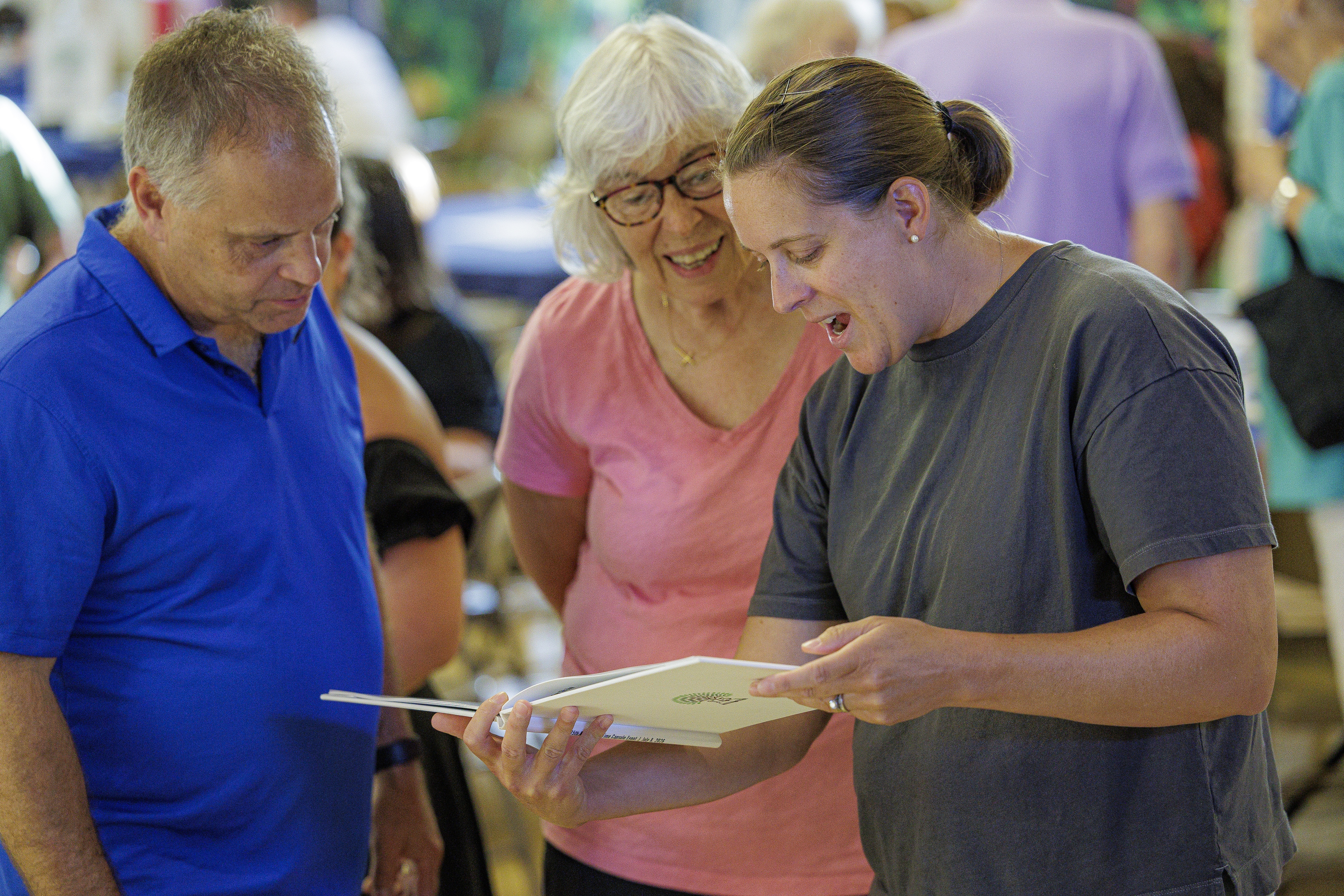 Members looking through the photo album made for the time capsule