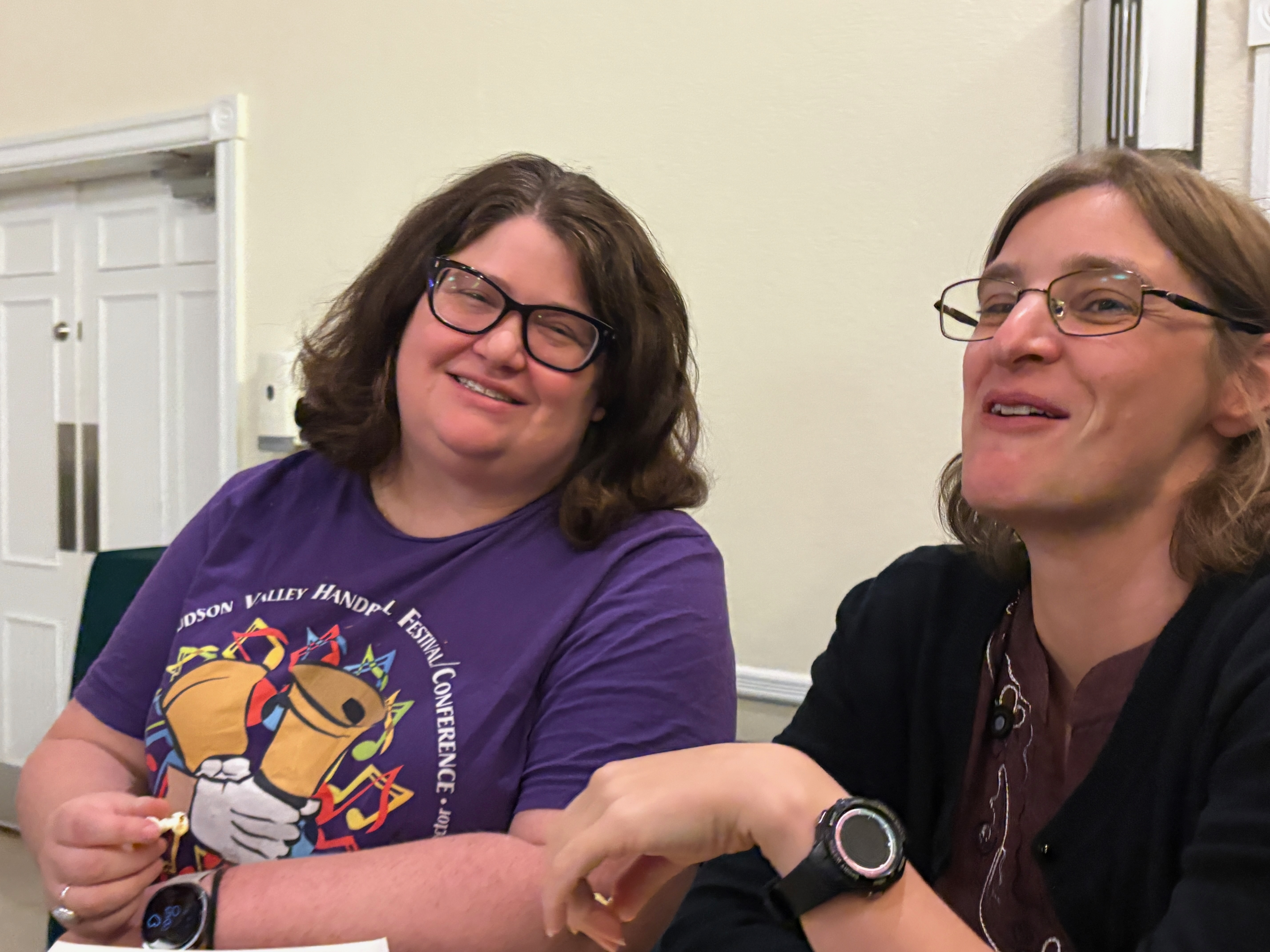 Two friends laughing together at their table