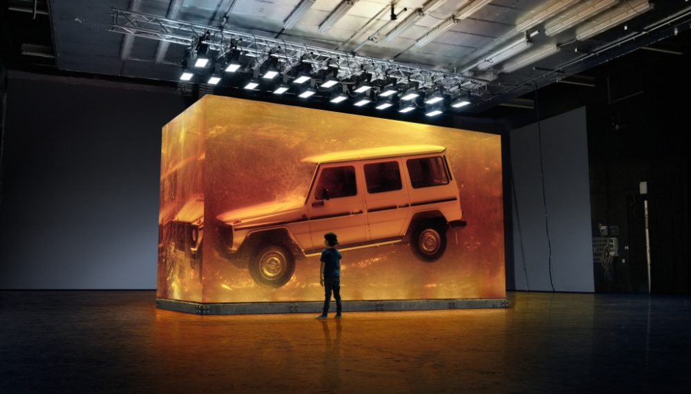 Making Of: Snapshot with a young viewer during the photo production. With the world's largest installation made of synthetic resin, Mercedes-Benz will focus on the world premiere of the new G-Class on 14 January 2018 at the North American International Auto Show (NAIAS) in Detroit. Copyright Daimler AG, photo by: Hans Starck