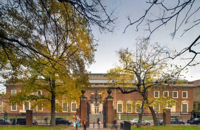 A view of the red brick facade of the Harvard Art Museums from inside Harvard Yard.